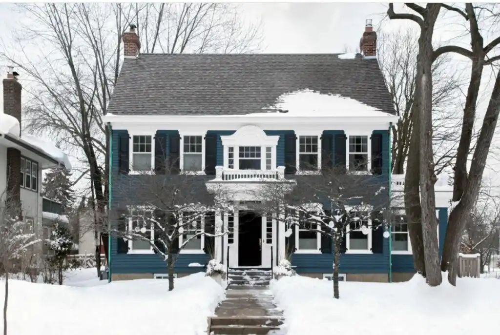 Classic blue house in snow 1024x687