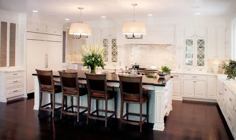 Classic white kitchen dark wood floor and traditional counter stools