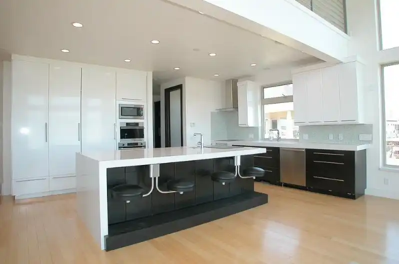 Contemporary kitchen black island face with built in seating