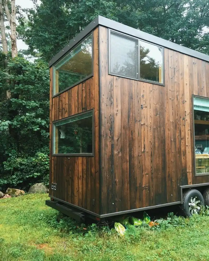 The dark cedar siding adds an elegant and homely touch to the overall design of this tiny house