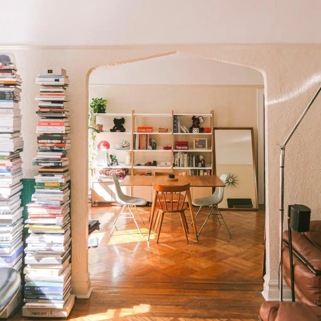 Dining room with books and wood floors 1024x1024