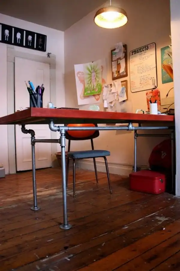 Diy desk of salvaged door and pipes