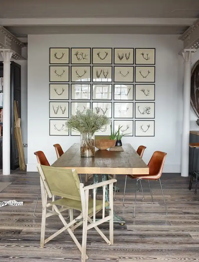 industrial loft dining area with a collection of framed pictures