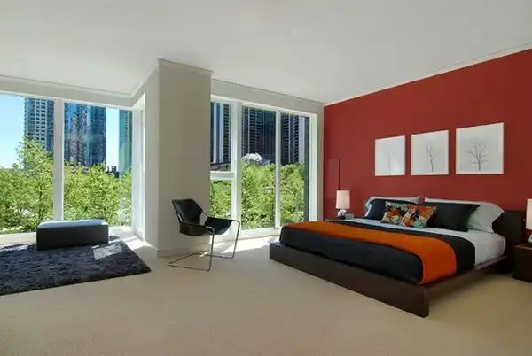 Modern bedroom with red wall and white framed art