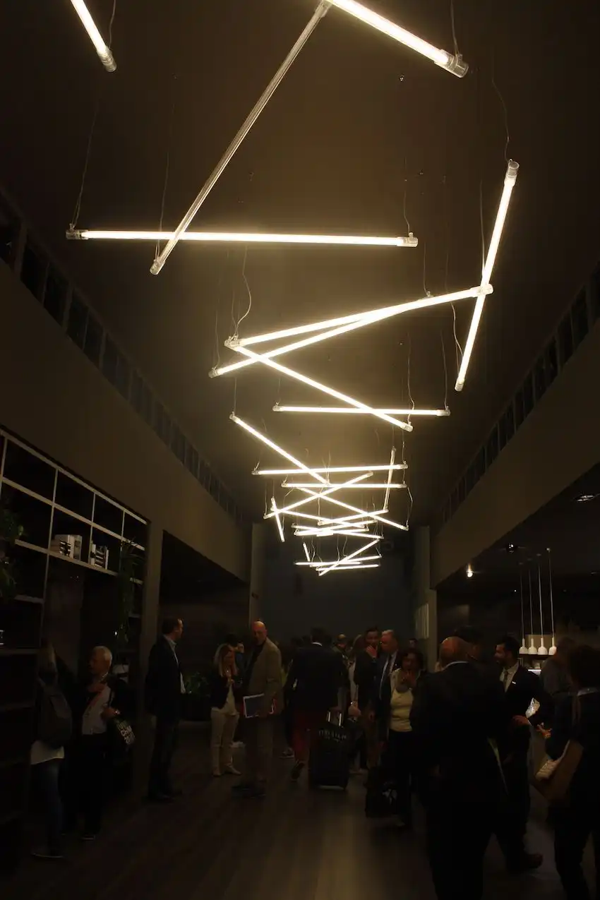 Multiples of one simple stick light make for a dramatic display in the Scavolini booth. We can see a similar arrangement serving as kitchen island lighting.