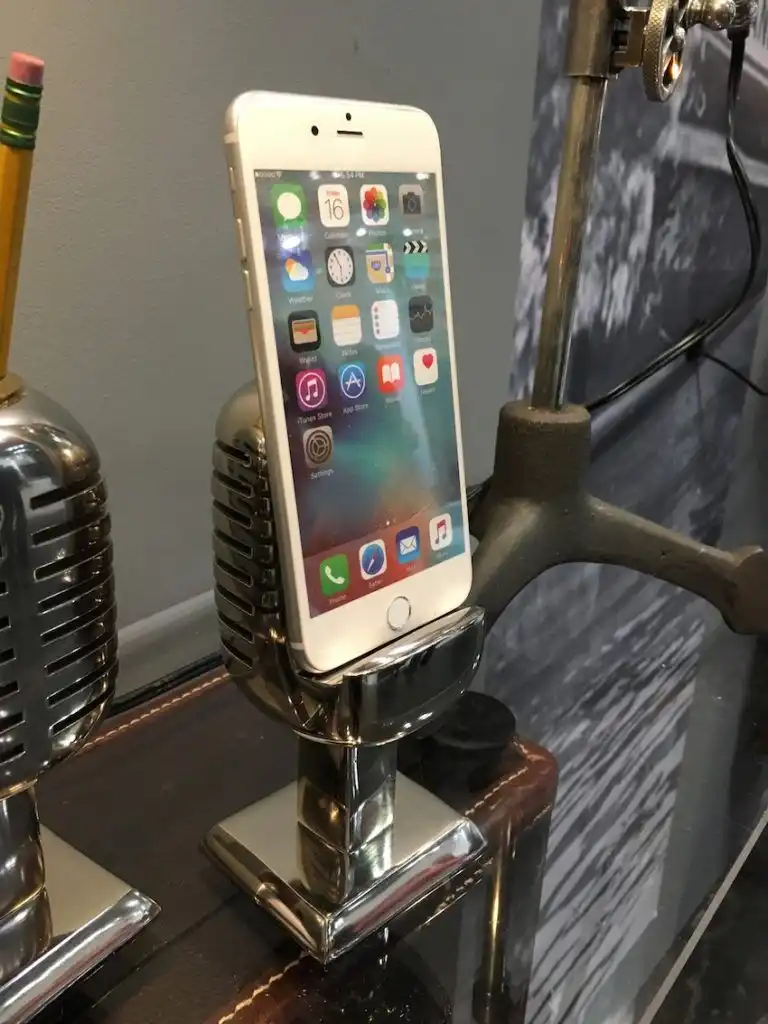 The microphone stand has an opening to run the charging cord up through the base.
