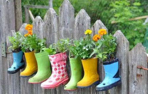 Rainboot garden on a fence