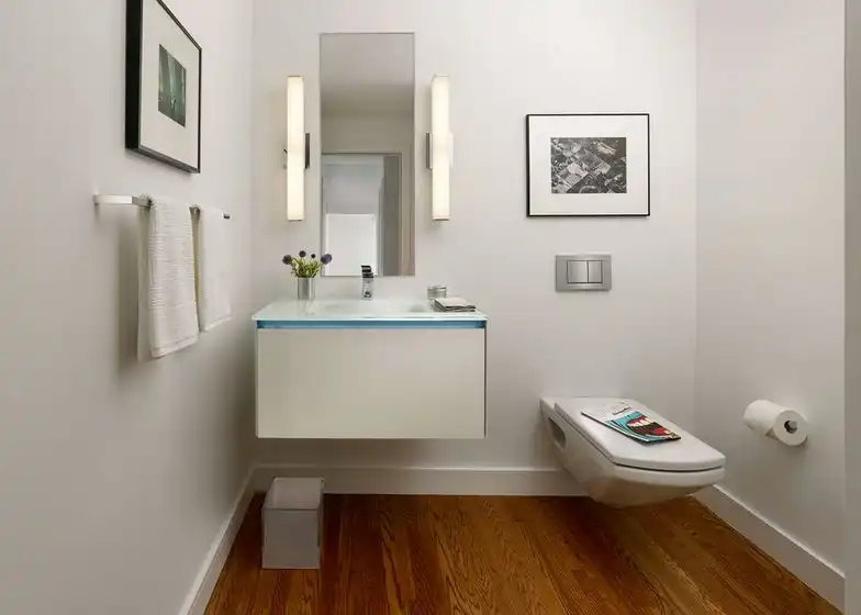 Small poweder room hanging wall art and floating toilet