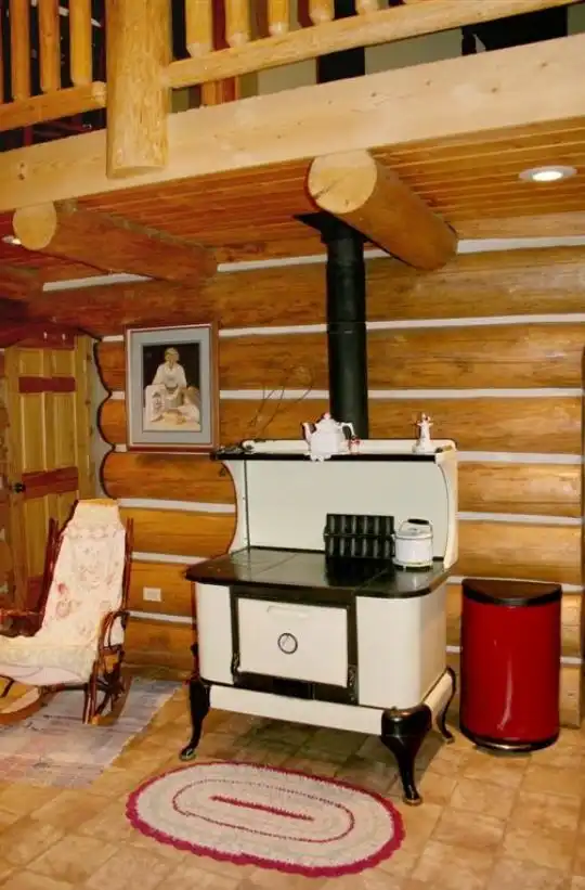 White and black cookstove on log wall