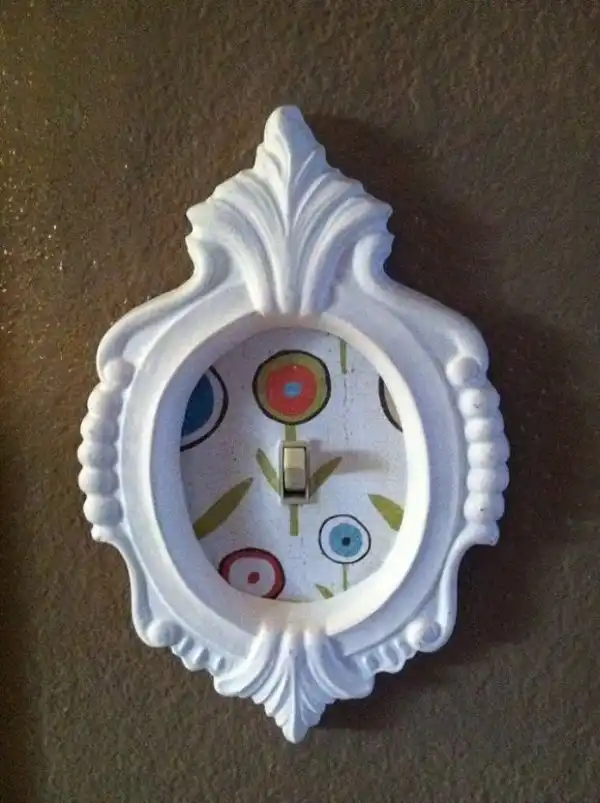 White framed lightswitch cover