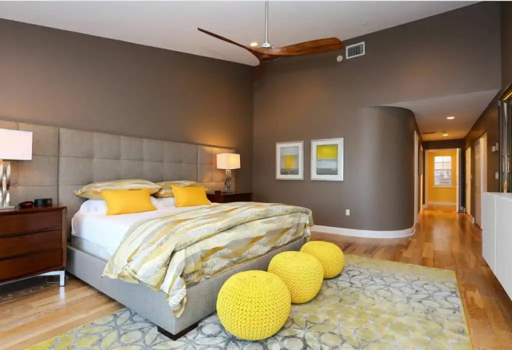 Yellow and gray bedroom with three crocheted poufs 1024x701