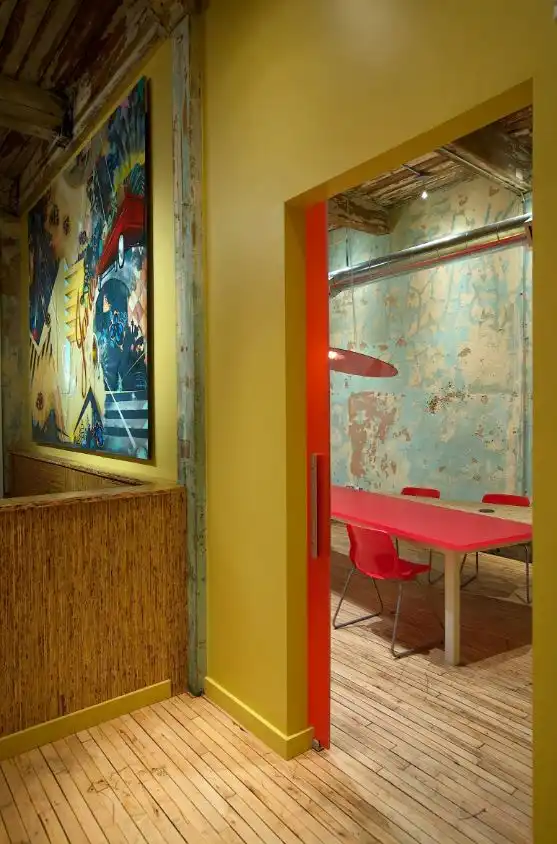 Yellow and red room with wood floors plaster walls 1