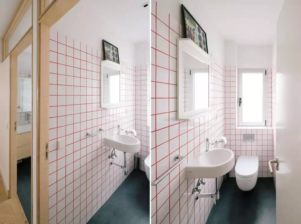 Bathroom featuring white tiles and pink grout