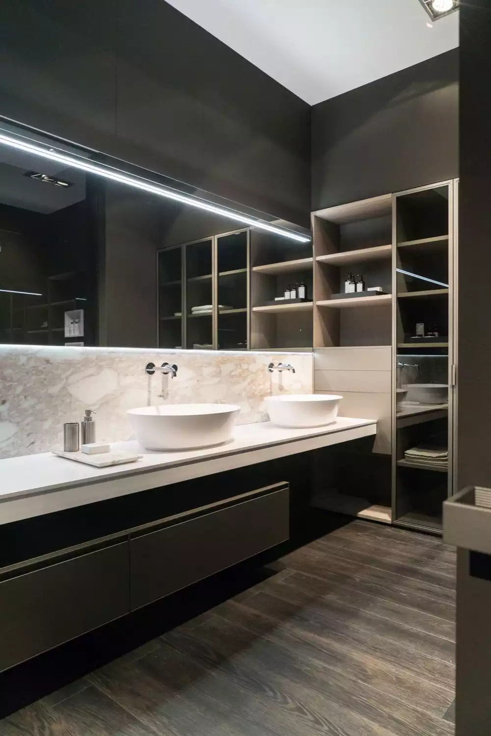 Bathroom with marble countertop and backsplash featuring two large vesel washing bowls