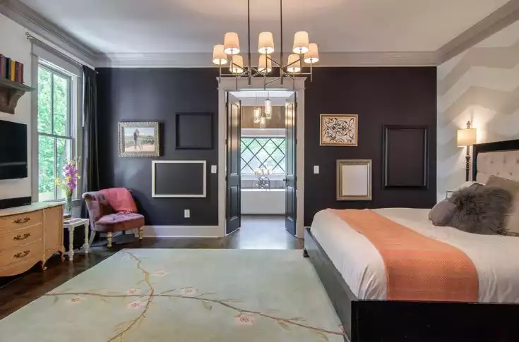 Bedroom with black waslls and empty frames