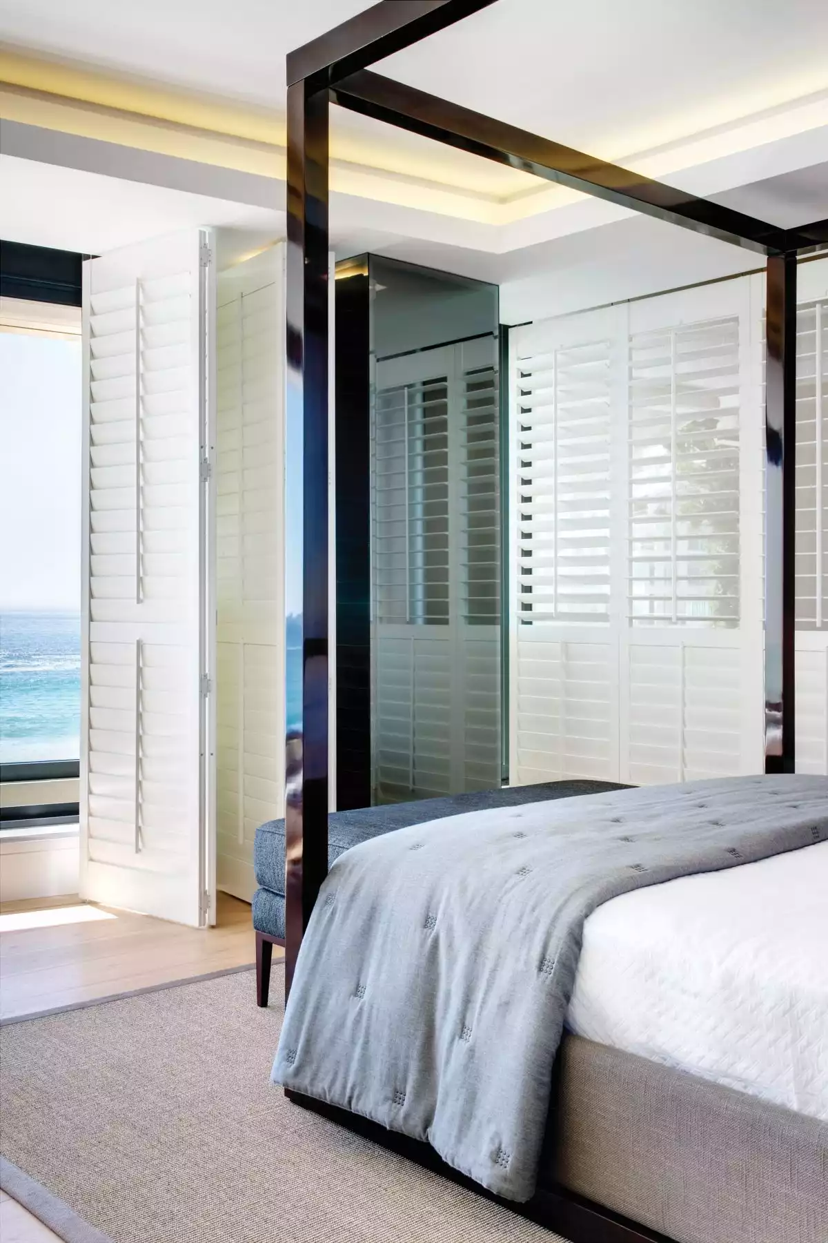 The wooden shutters giving the bedrooms a particularly casual look, in tone with the breezy ocean views