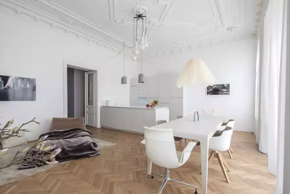 Clean living room featuring natural wood chevron parquete