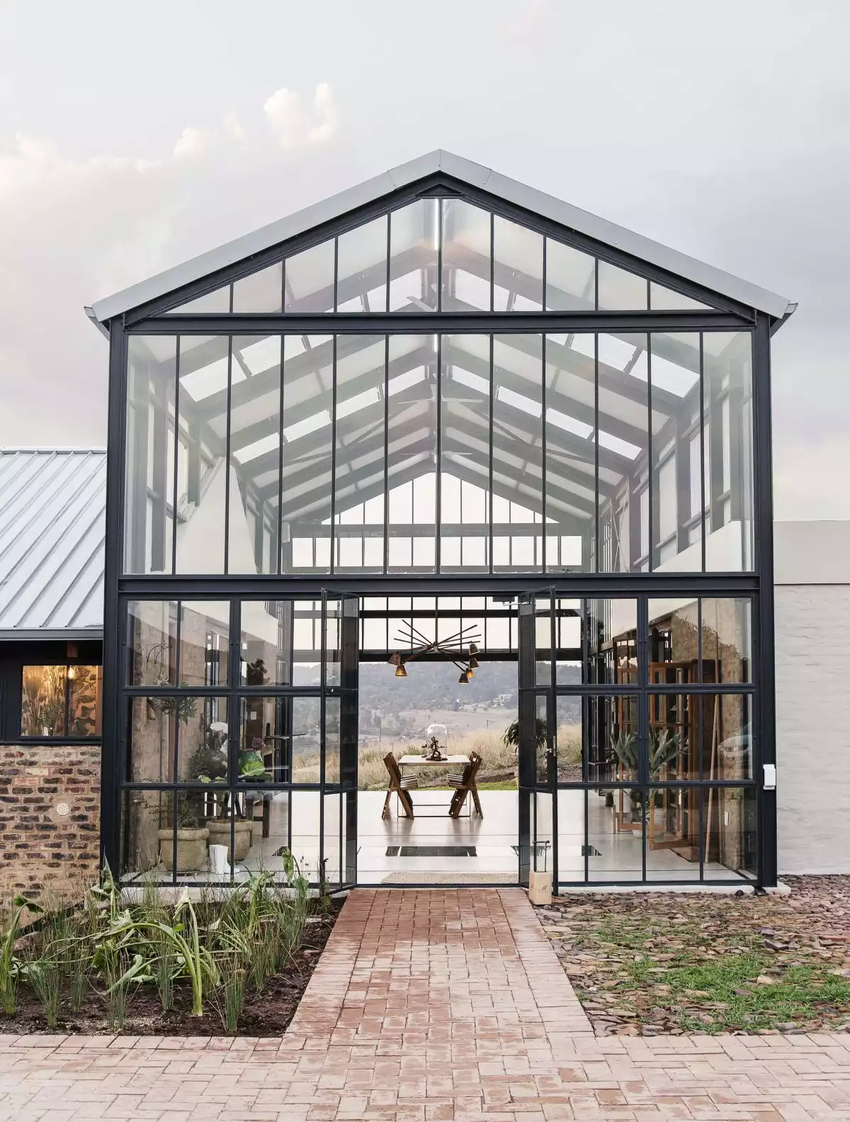 Conservatory is just another term for describing a sun lounge or a room with a glass roof and walls, similar to a greenhouse