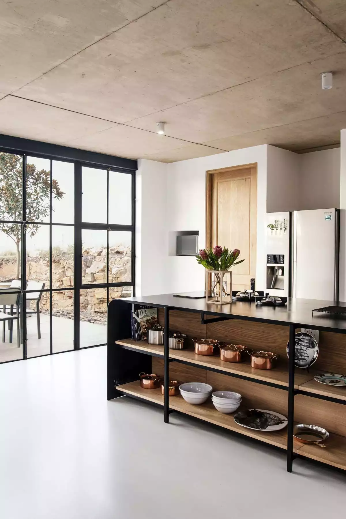 The palette of materials used throughout the house includes durable and low-maintenance choices such as concrete, steel or brick
