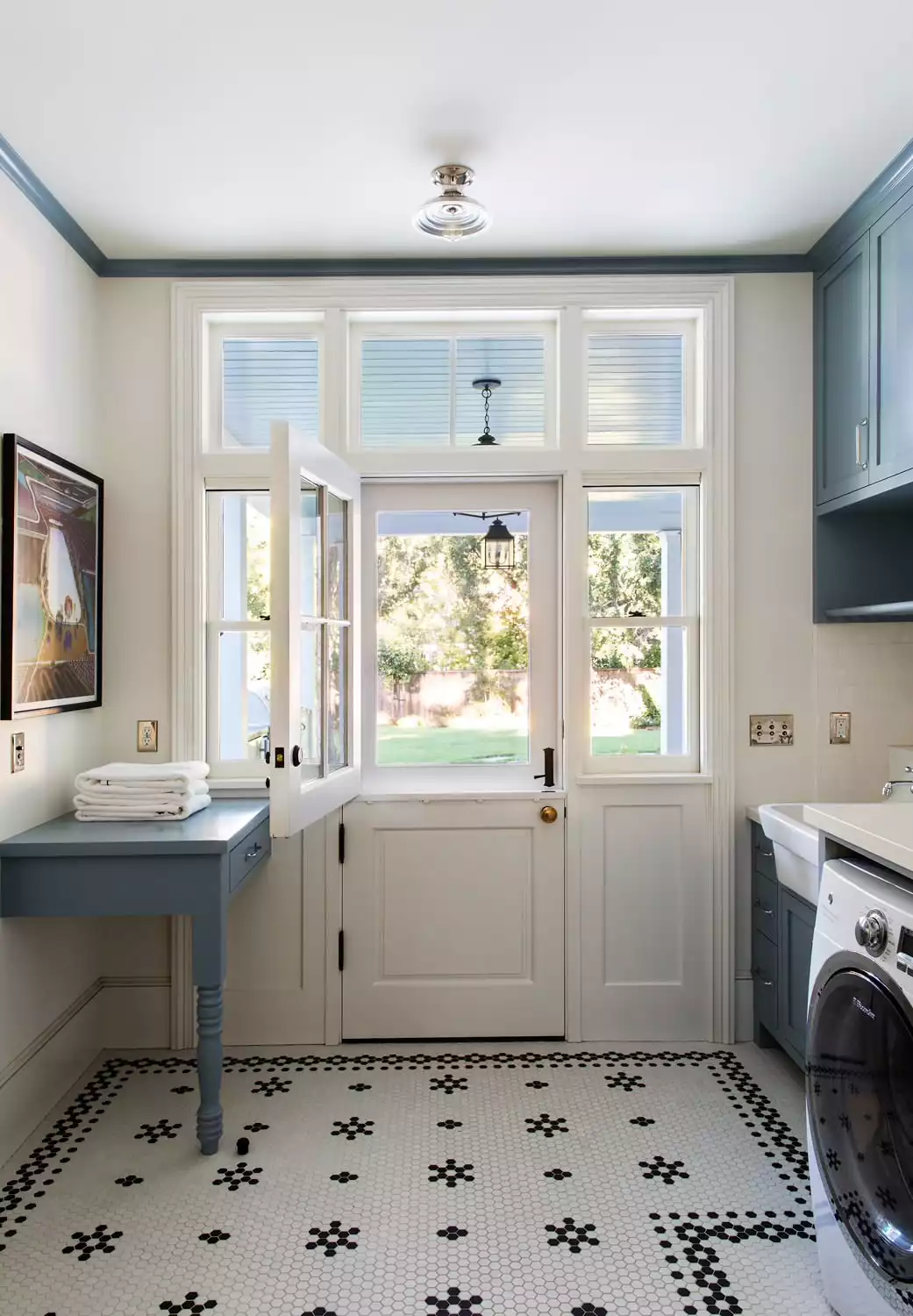 Farmhouse laundry room tiled floor blue cabinets