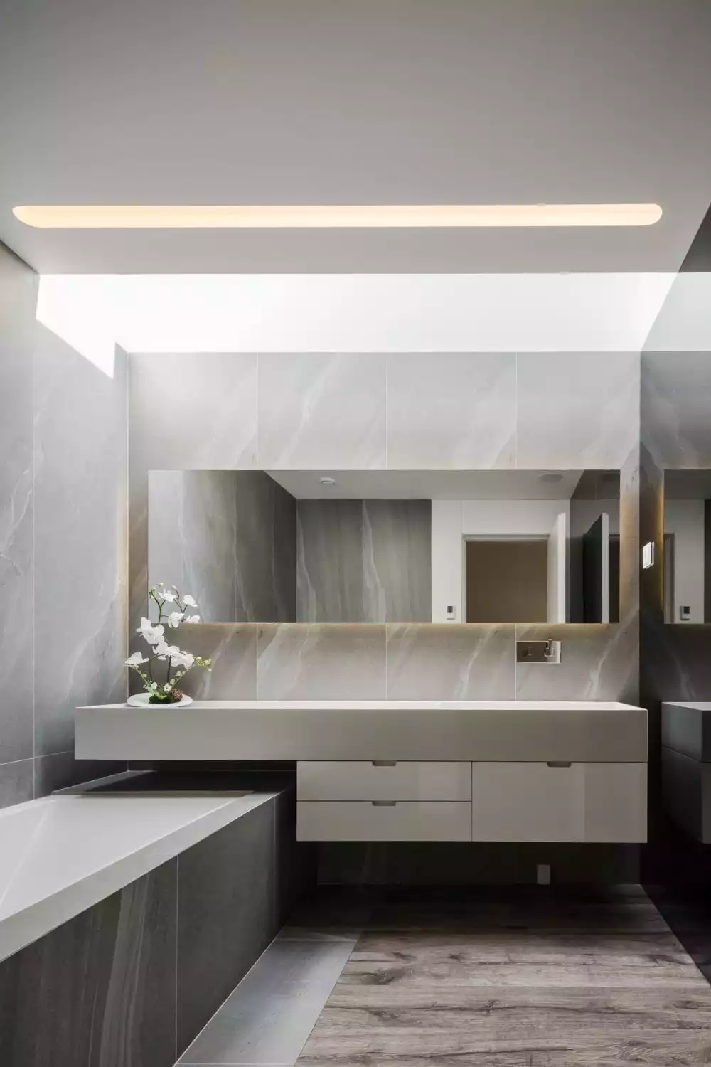 There's no shortage of natural lighting, not even in the bathrooms where skylights open up the decor