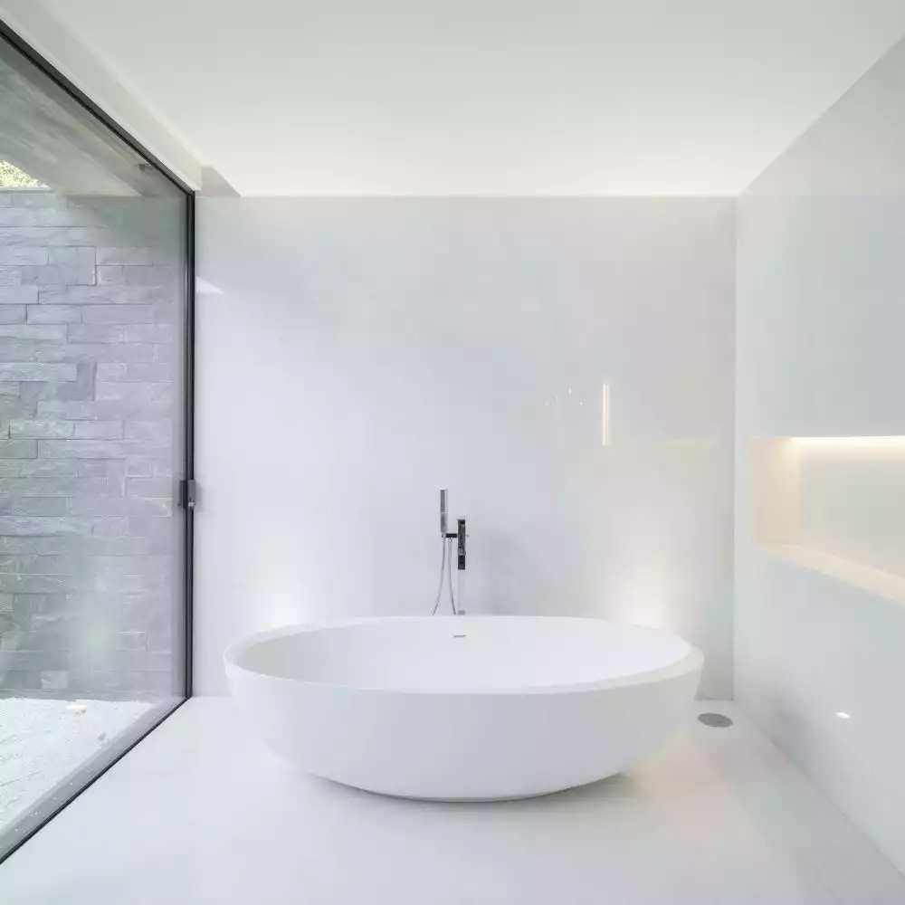 Instead of a skylight, this bathroom section features a full-height window which brings the outdoors in