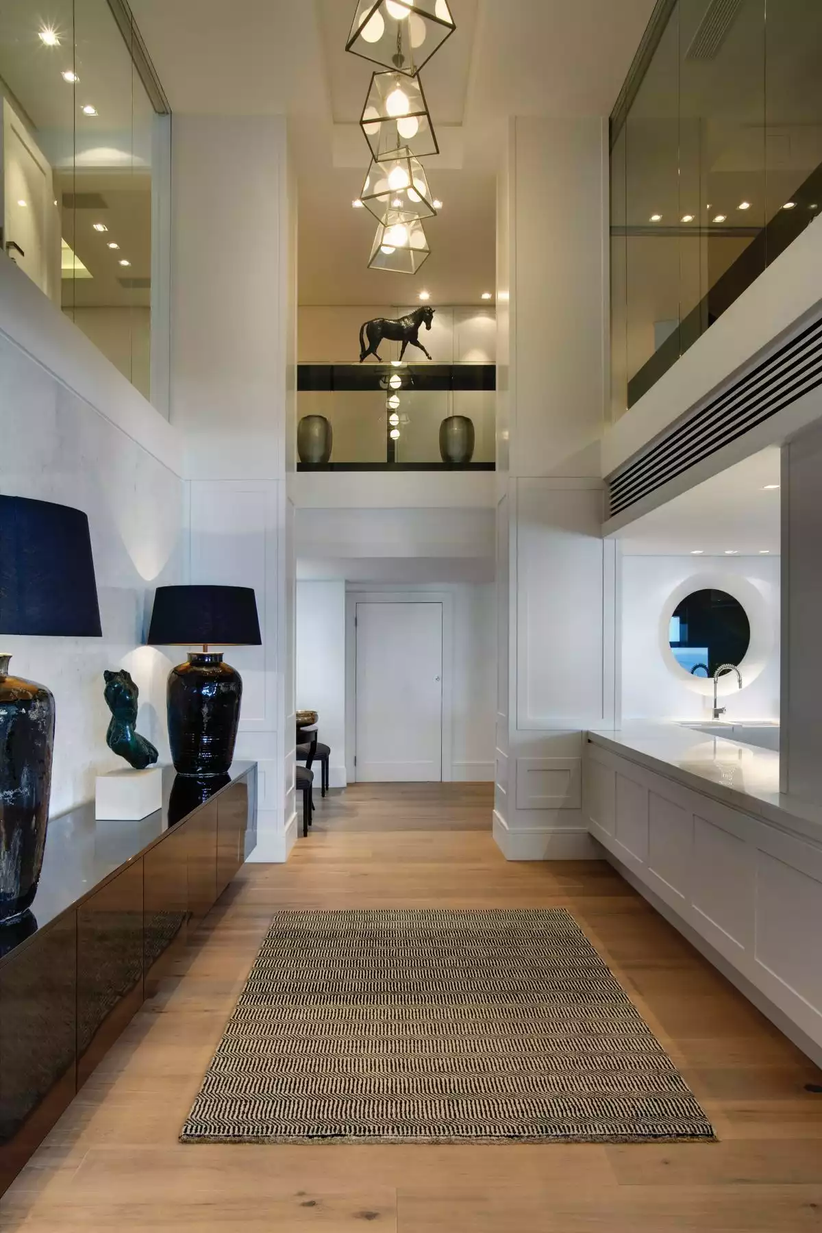 This double-height hallway connects the two floors and allows light to travel from one space to another