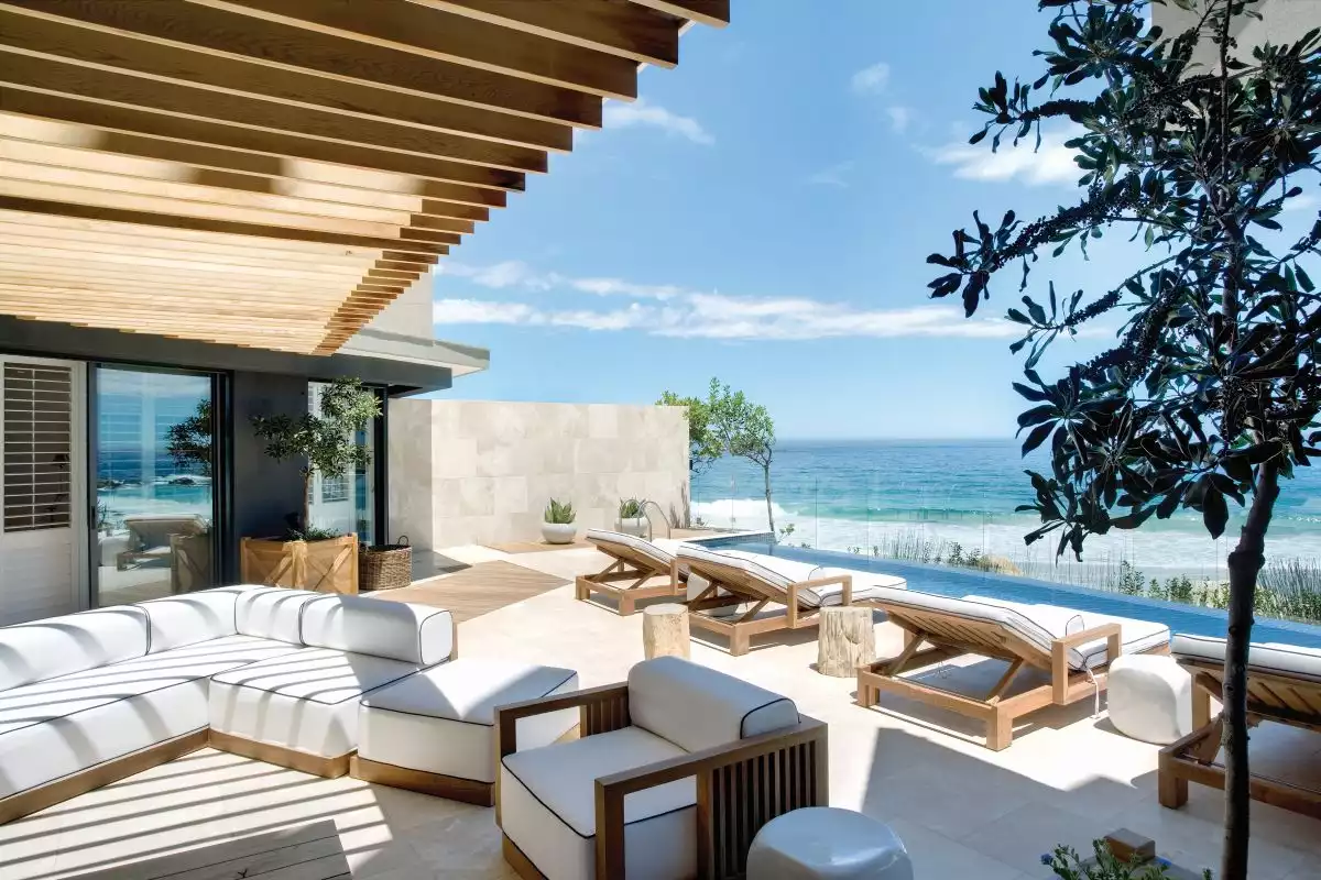 The outdoor pergola and the terrace spaces act as extensions of the indoor living areas