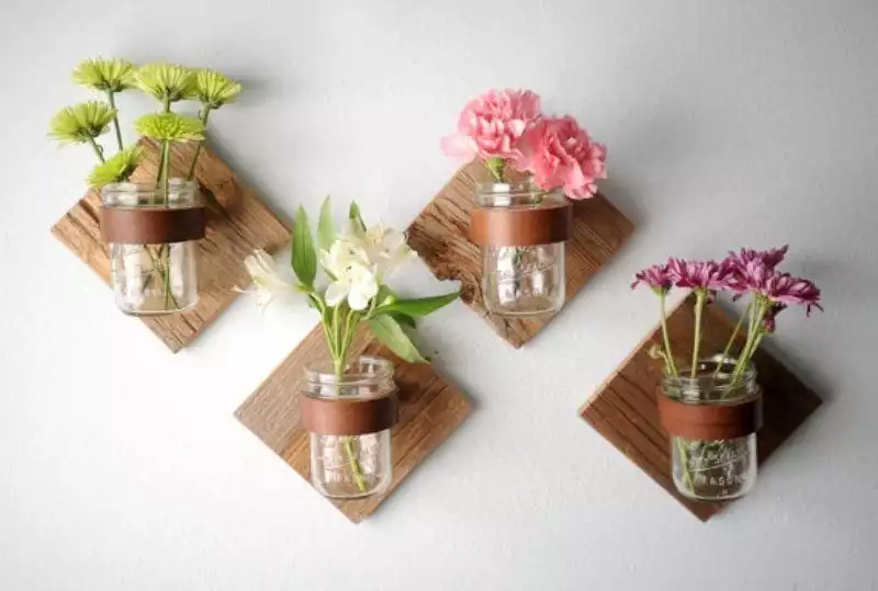 Mason jars on wall flowers