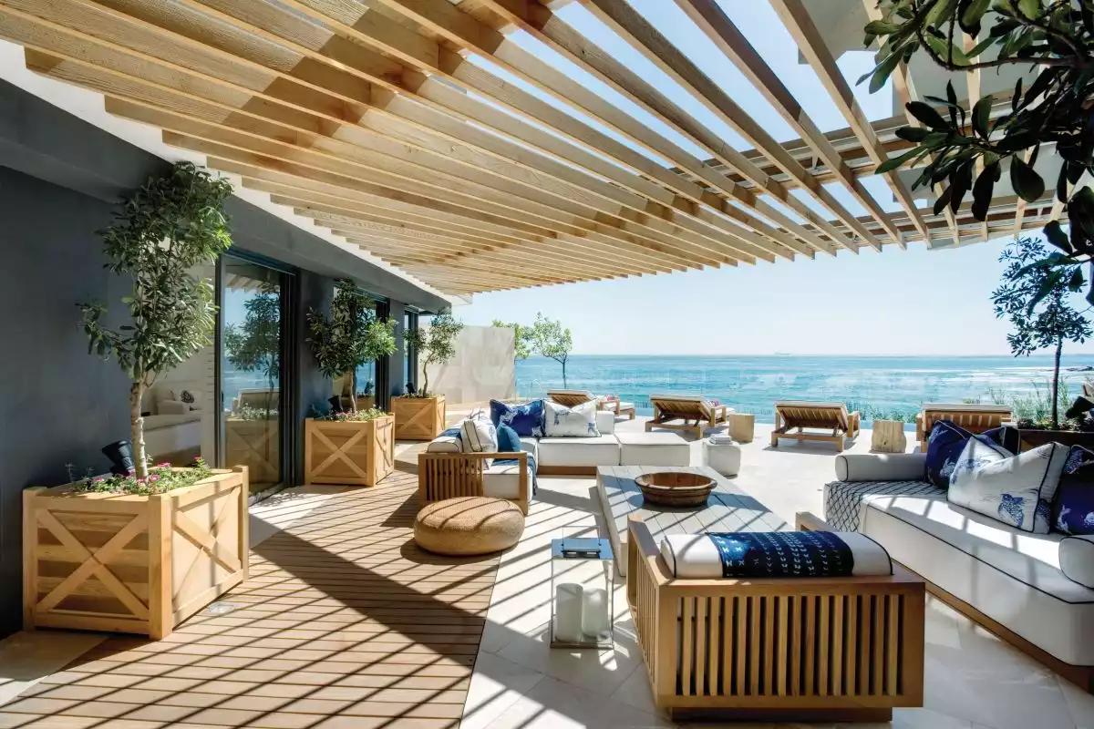 A large timber pergola extends the living spaces outdoors and offer magnificent views of the ocean and the blue sky