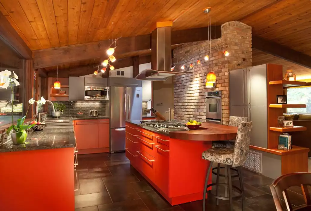 Red kitchen cabinets and exposed bricks