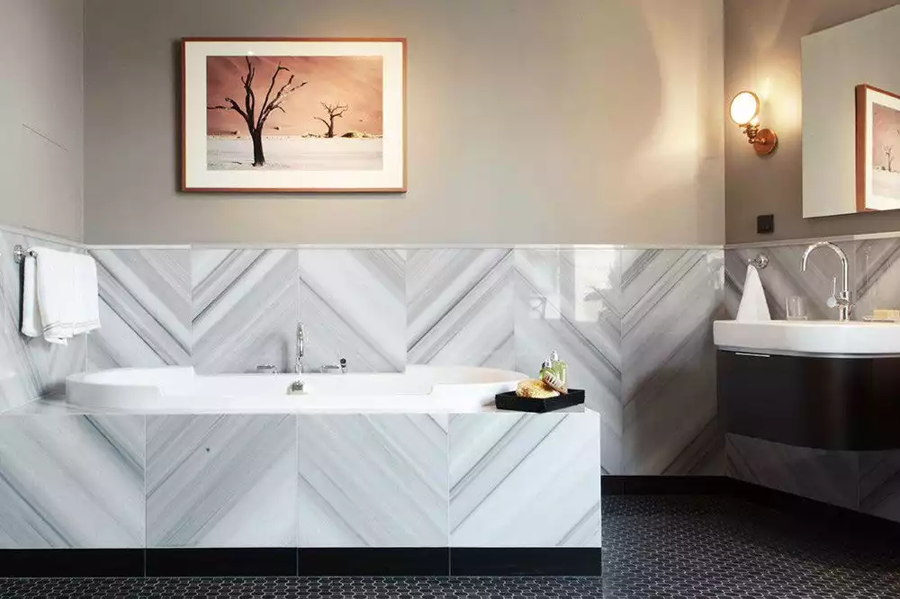 SOG Interiors Bathroom with Chevorn marble tiles