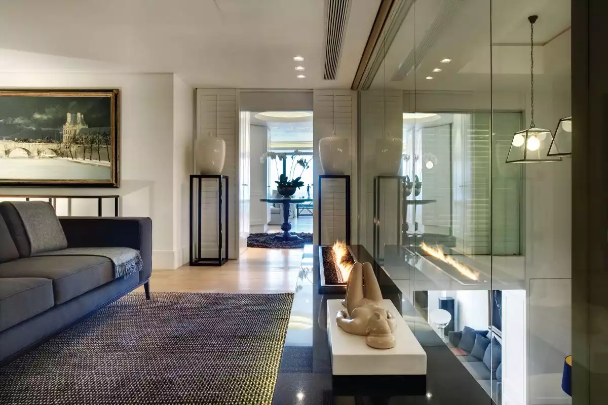 Soft fabrics, textured area rugs and classic shutters tone down the opulence and add warmth to the rooms