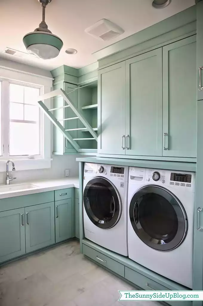 Turquoise laundry room with drop down clothes rack