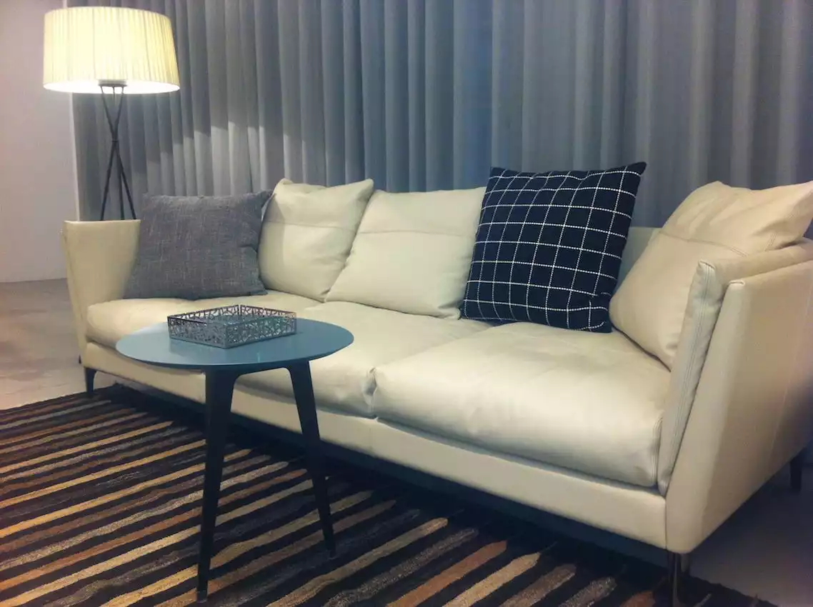 This hard wedge armed sofa has an additional cushion along the side.