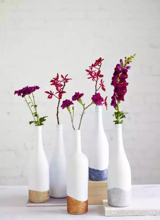White painted wine bottles with gold glitted