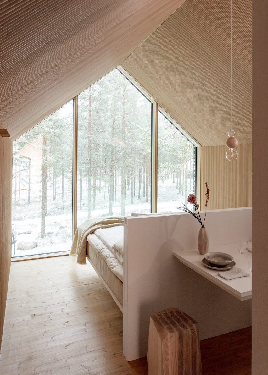 A cabin perched on a single column bed area