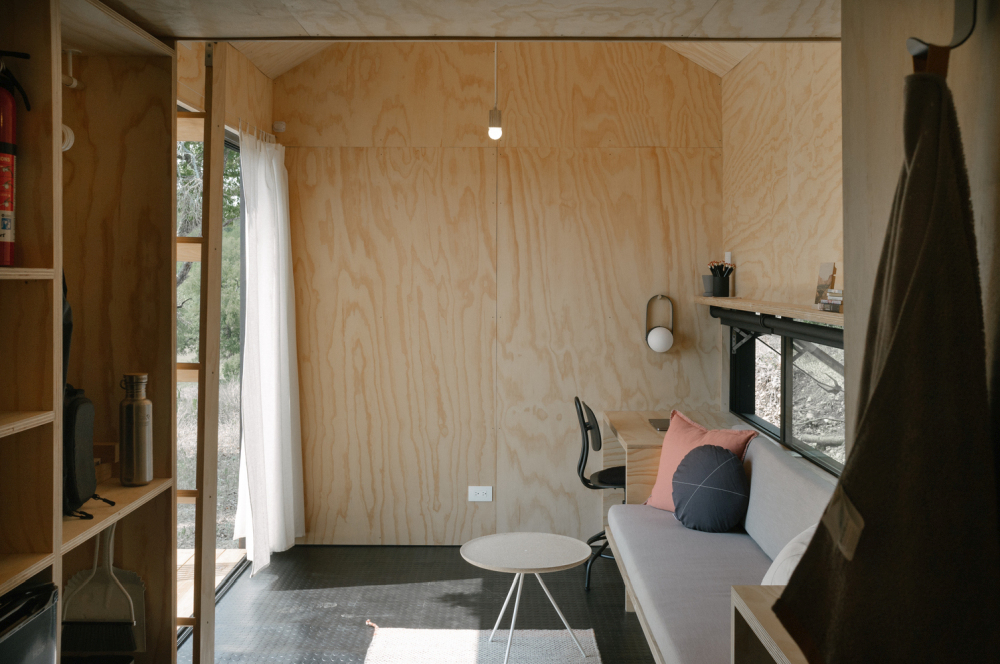 A compact retreat with a folding glass wall interior