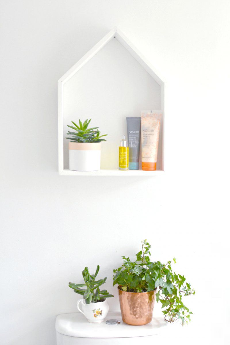 A shaped house shelf for nursery room organization storage