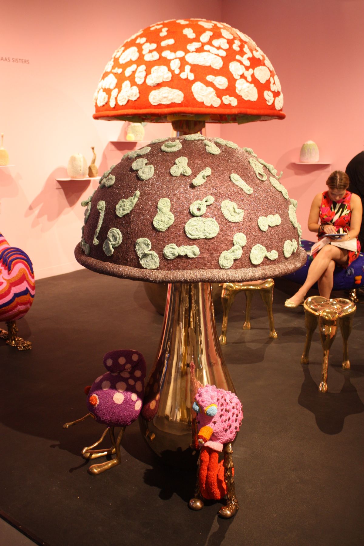 Giant beaded mushrooms are accompanied by small, imaginary creatures.