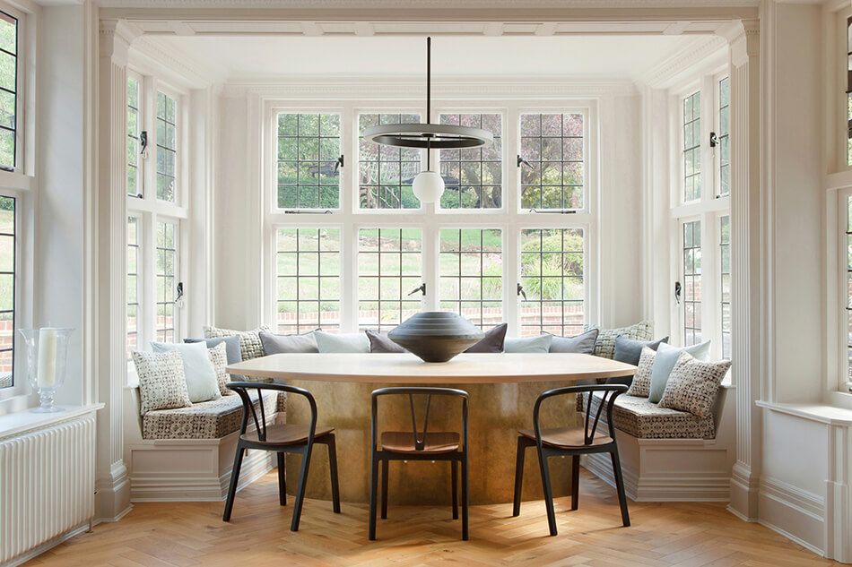 Alcove dining area with large windows and bench seating