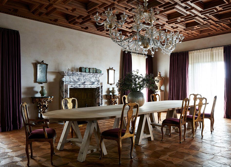 Alexandra and Michael Misczynski of Atelier AM dining room design with a large table and big chandelier over