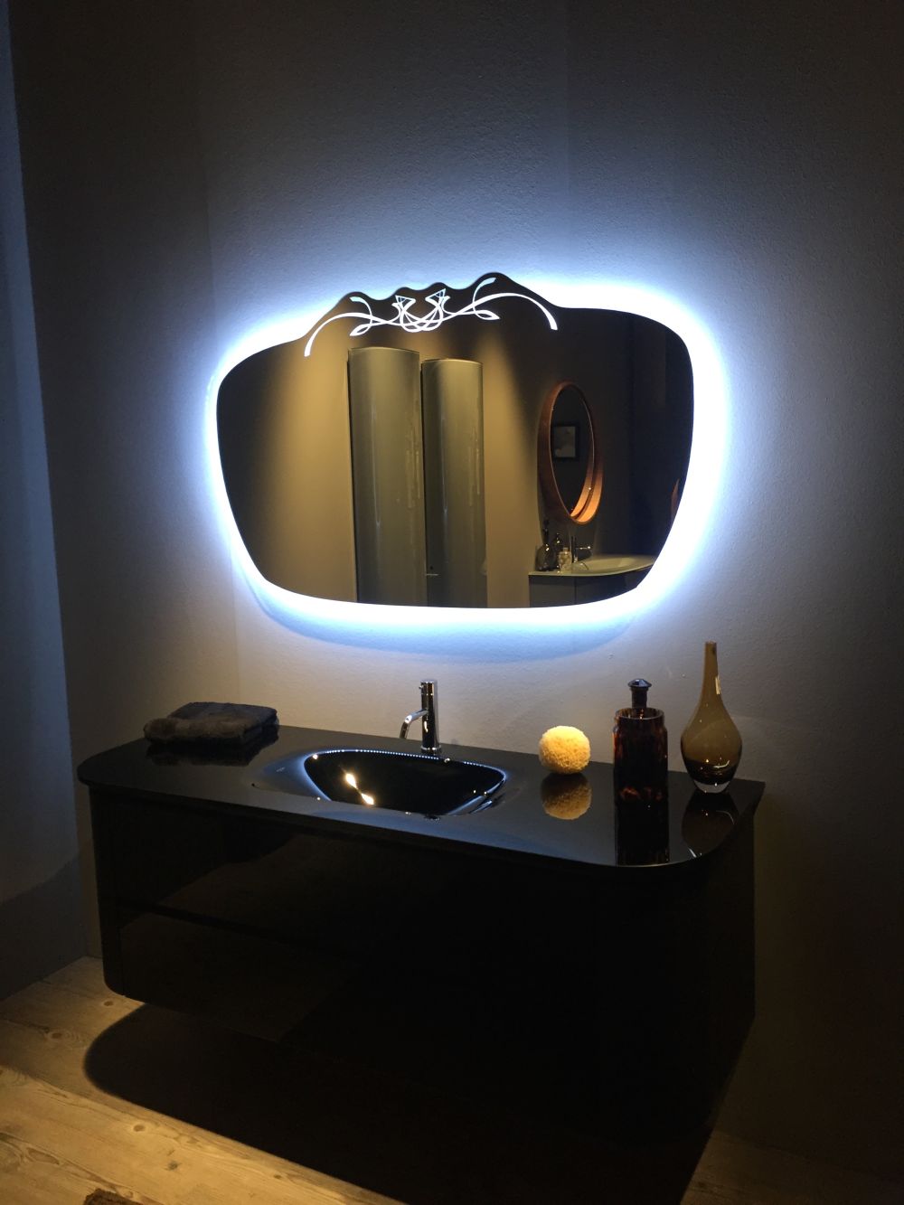 Amazing Look of the black bathroom vanity and backlit mirror