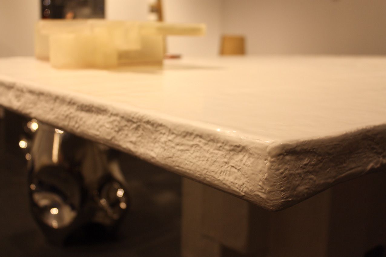 A side view of the table shows that it's not just a plan slab of material.