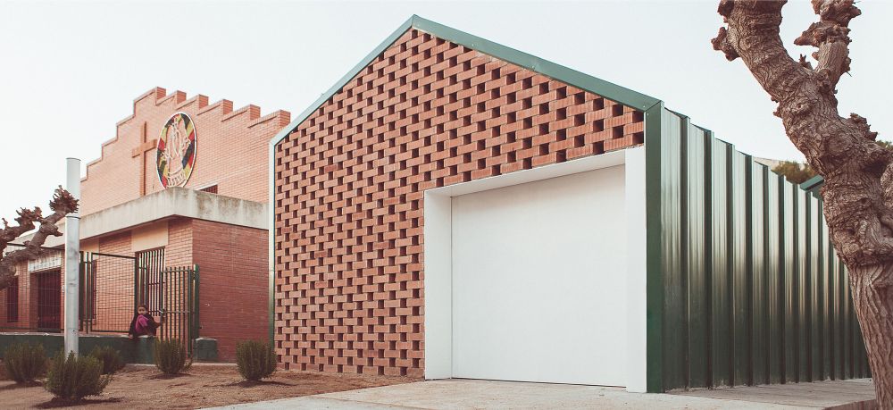 Angle Perforated and stacked bricks facade - NUA Arquitectures