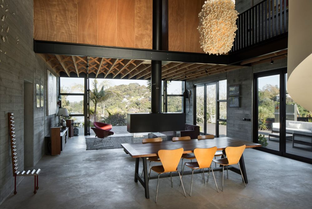 Concrete is mixed with wood and stylish furniture and light fixtures and the combination is exquisite
