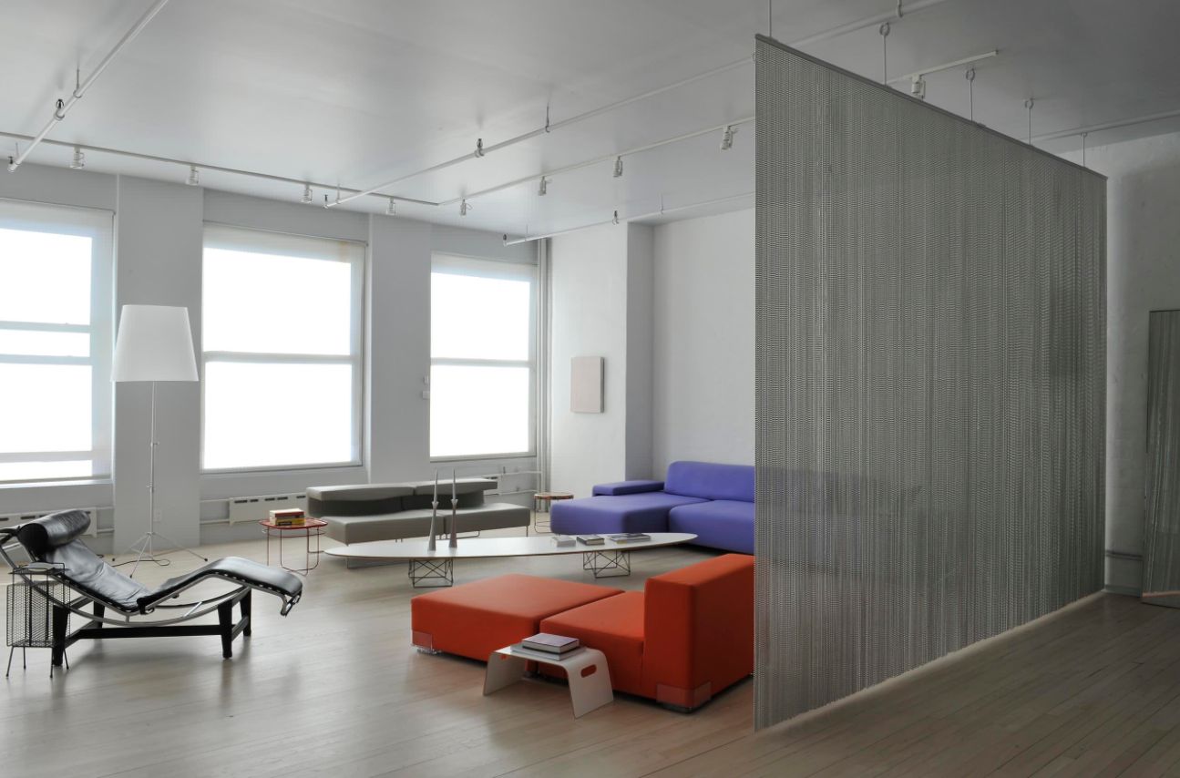 Artist loft room divider through a metalic curtain