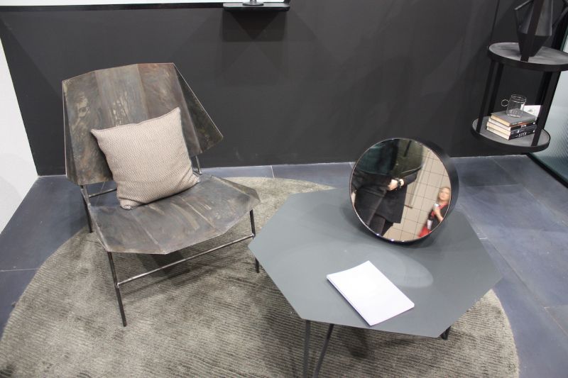 Atipico's hexagon-shaped table has an industrial vibe thanks to the gray color. The hairpin style legs keep it modern and tabletop's shape is an unexpected feature.