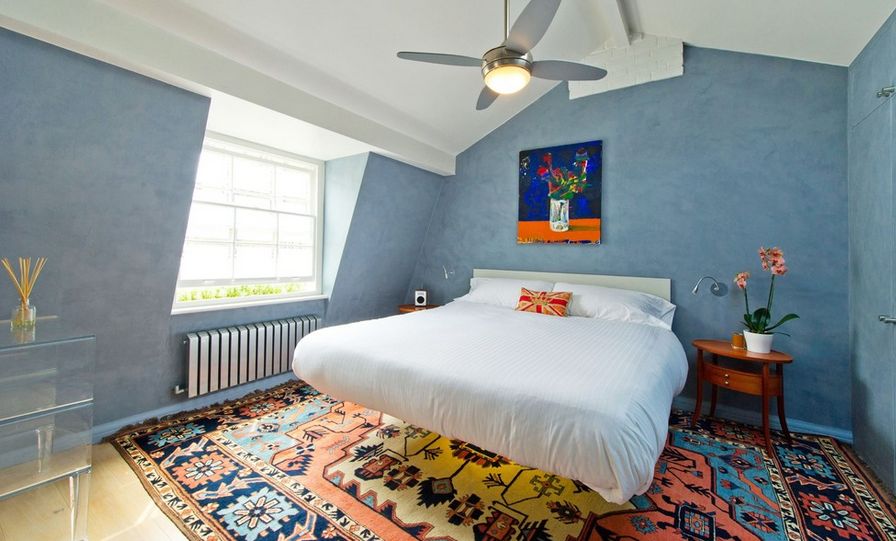 Attic bedroom with floating bed and carpet under