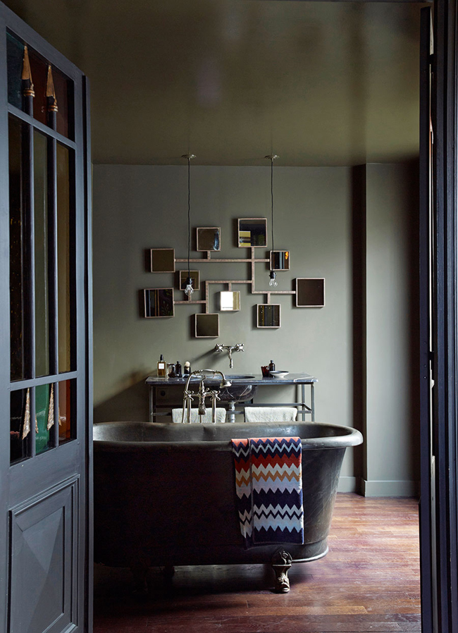 Bathroom with a teal color and decorative vanity mirror